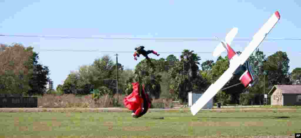 This photo released by the Polk County Sheriff's Office shows a plane nose-diving into the ground after getting tangled with a parachutist, at the South Lakeland Airport in Mulberry, Fla. Both the pilot and jumper were hospitalized with minor injuries, March 8, 2014.