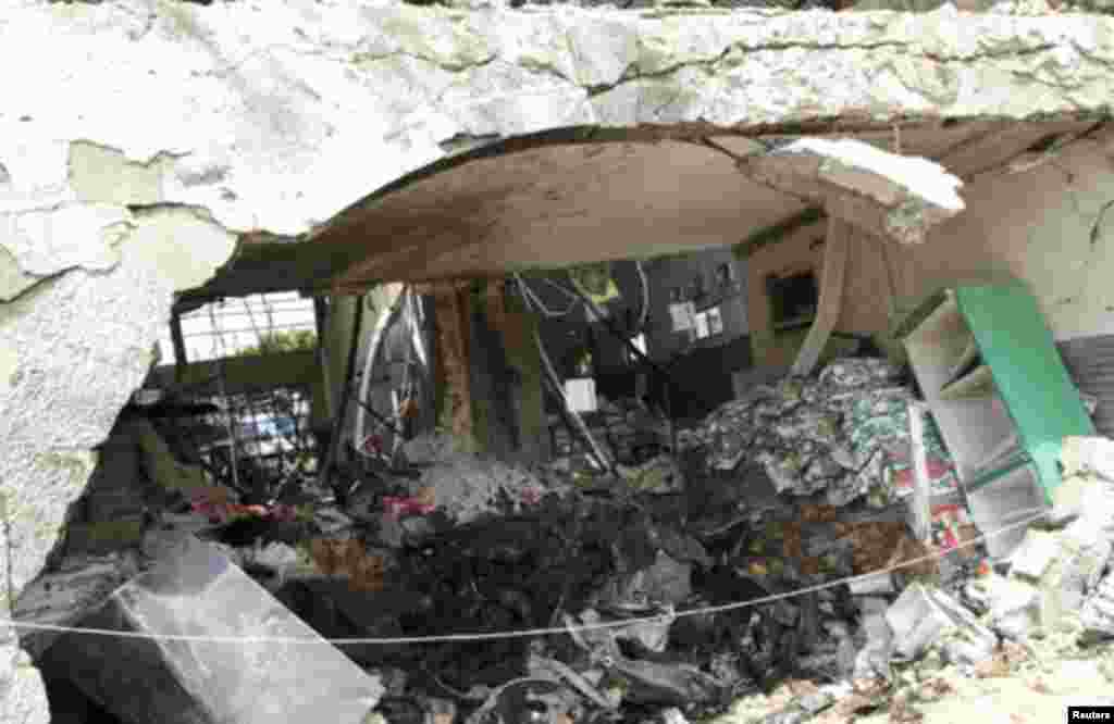 Burnt newspaper copies are seen in the rubble of a destroyed This Day newspaper building in Abuja April 28, 2012. Suicide car bombers targeted the offices of Nigerian newspaper This Day in the capital Abuja and northern city of Kaduna on Thursday, killing