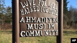 FILE - A sign bearing the words "Love for all, hatred for none" stands outside a mosque in Meriden, Connecticut, Feb. 27, 2016. Hafiz Abdul Hannan, the leader of the Masjid Al-Islam mosque in New Haven, Connecticut, was detained Tuesday and faces deportation to Pakistan.