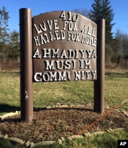 FILE - A sign bearing the words "Love for all, hatred for none" stands outside a mosque in Meriden, Connecticut, Feb. 27, 2016.