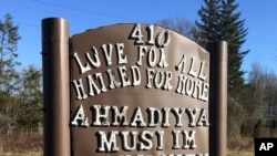 FILE - A sign bearing the words "Love for all, hatred for none" stands outside a mosque in Meriden, Connecticut, Feb. 27, 2016.