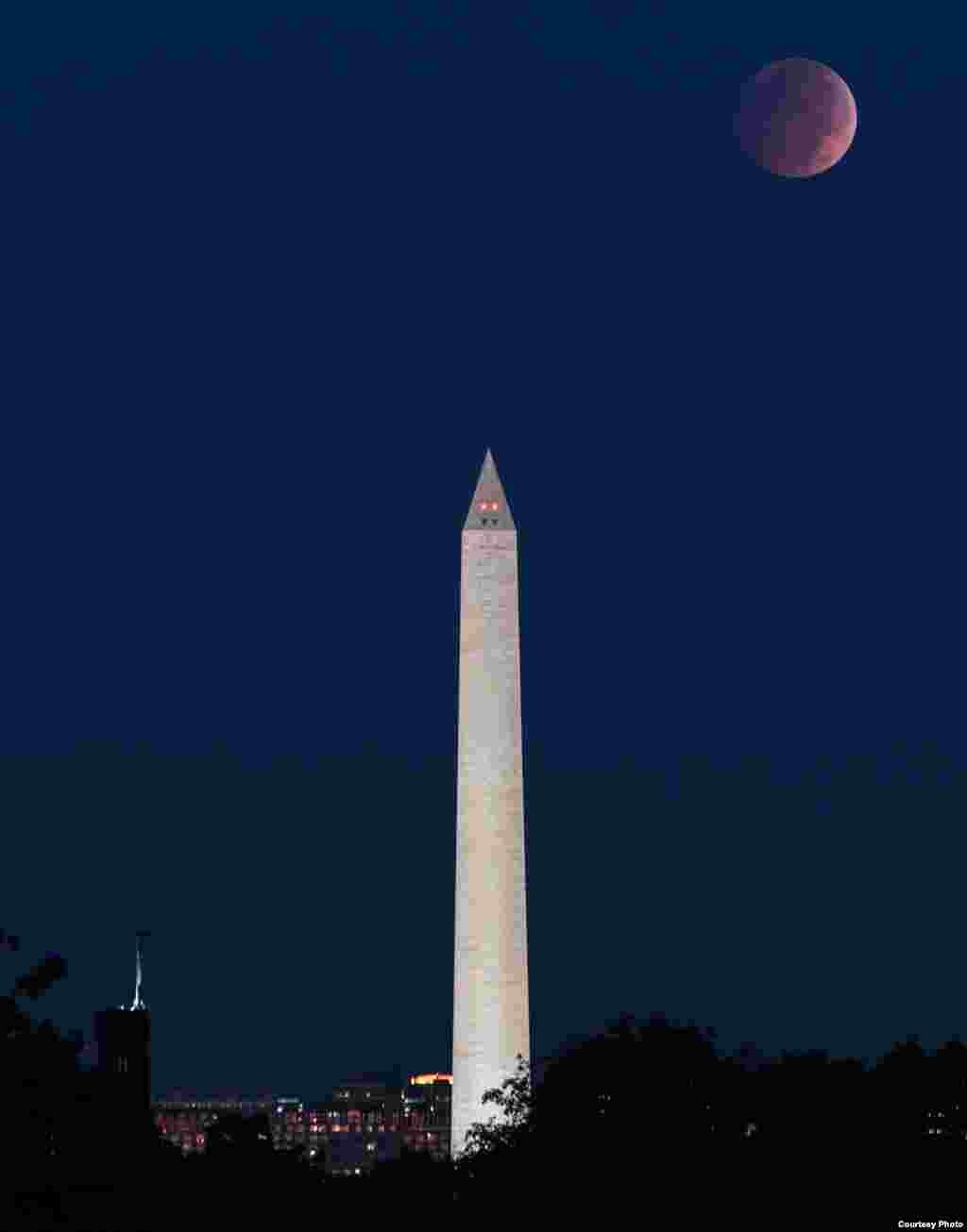 Earth’s shadow creates a blood moon in this lunar eclipse with the Washington Monument in Washington, D.C., Oct. 8, 2014. This only occurs when the Sun, Earth and Moon are aligned, with the Earth in the middle. (Credit: Jim Dougherty)