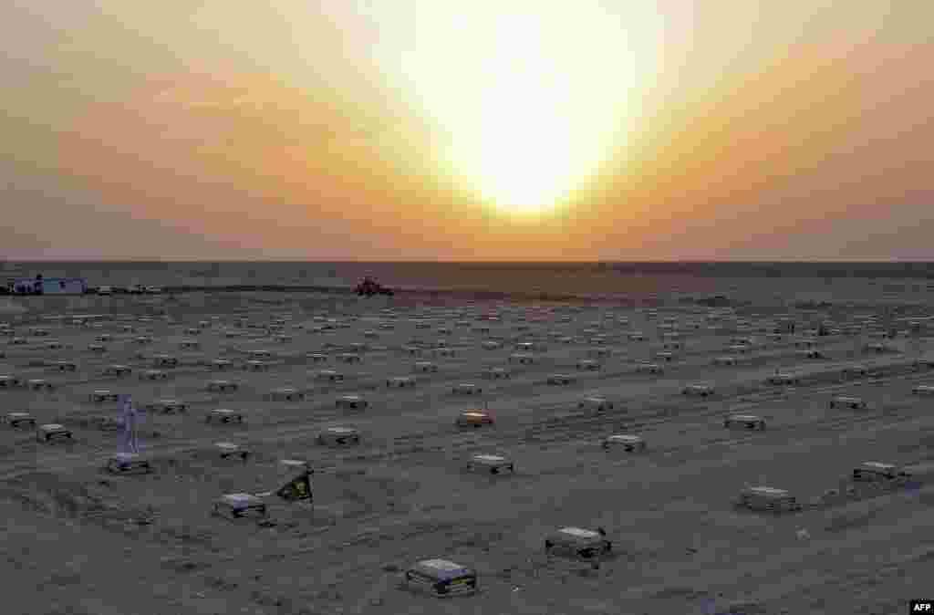 The sun sets over a cemetery for COVID-19 victims, 20 kilometers from the central Iraqi holy city of Najaf, June 10, 2020.