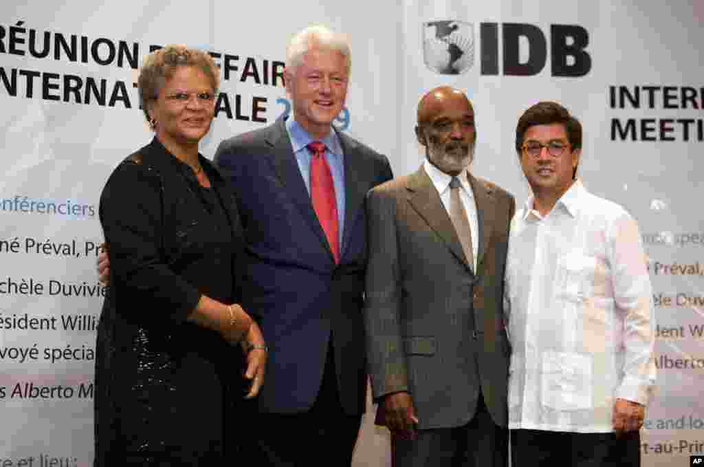 From left: Haiti's Prime Minister Michele Pierre-Louis, UN special envoy to Haiti and former US President Bill Clinton, Haiti's President Rene Preval and Inter American Development Bank, IDB, President Luis Alberto Moreno pose for pictures during an IDB m