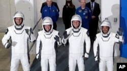 FILE - From front left, European Space Agency astronaut Thomas Pesquet, NASA astronaut Megan McArthur, NASA astronaut Shane Kimbrough and Japan Aerospace Exploration Agency astronaut Akihiko Hoshide leave the Operation and Checkout Building at the Kennedy