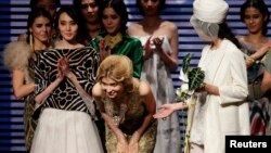 Gulnara Karimova ( C), daughter of Uzbekistan's President Islam Karimov, acknowledges the audience after her Collection at China Fashion Week in Beijing October 30, 2012. (REUTERS/Jason Lee)