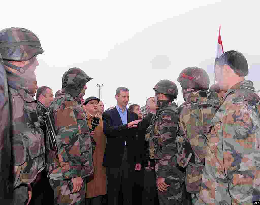 Syrian President Bashar al-Assad speaks to soldiers during a tour in Baba Amr. (Reuters / SANA)