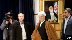 FILE - Former Iranian President Akbar Hashemi Rafsanjani, center, arrives for a press briefing after registering his candidacy for the Feb. 26 elections of the assembly at interior ministry in Tehran, Iran, Dec. 21, 2015. 