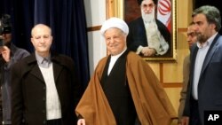 FILE - Former Iranian President Akbar Hashemi Rafsanjani, center, arrives for a press briefing after registering his candidacy for the Feb. 26 elections of the assembly at interior ministry in Tehran, Iran, Dec. 21, 2015. 