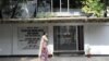 FILE - A woman walks past the former residence of Bangladesh’s 'founding father' Sheikh Mujibur Rahman, which is now a museum, in Dhaka, Bangladesh, Nov. 17, 2009.