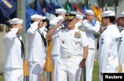 Vice Admiral Robert S. Harward, commander of Combined Joint Task Force 435, salutes during a SEAL Team 5 change of command ceremony in San Diego, California, July 11, 2011.