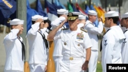 Vice Admiral Robert S. Harward, commander of Combined Joint Task Force 435, salutes during a SEAL Team 5 change of command ceremony in San Diego, California, July 11, 2011.