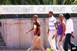 Black students walk past a university building named after President C.R. Swart, one of apartheid South Africa's leaders