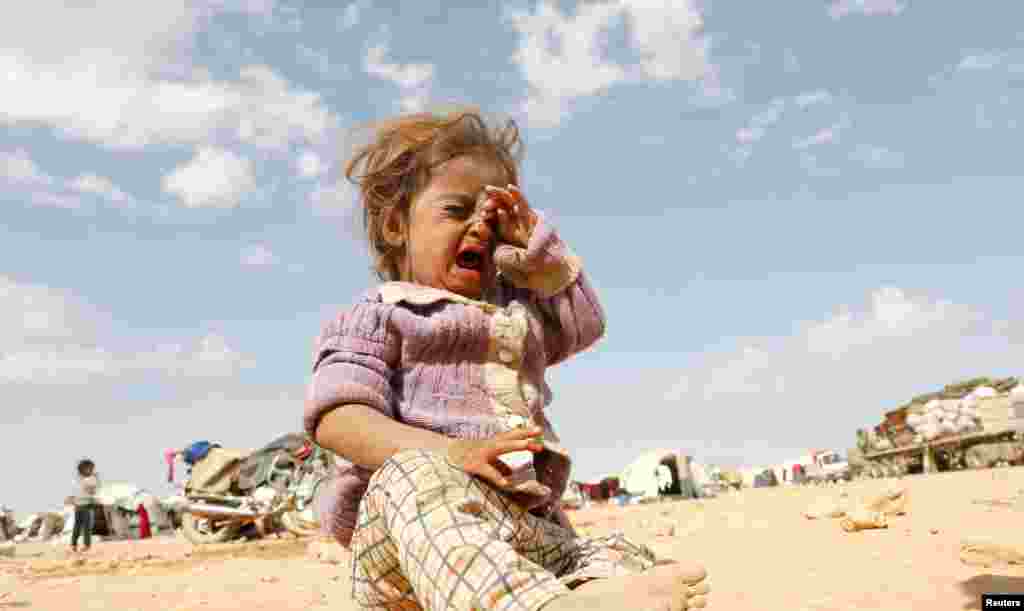 A girl cries at a refugee camp for people displaced in fighting between the Syrian Democratic Forces and Islamic State militants in Ain Issa, Syria, Oct. 14, 2017.