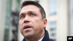 FILE - Rep. Michael Grimm speaks to reporters outside federal court in Brooklyn after pleading guilty to a federal tax evasion charge rather than go to trial, in New York, Dec. 23, 2014. 