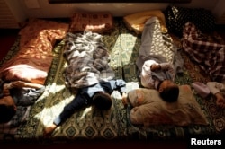 Younger students take an afternoon nap at the Al-Nadwa Madrassa in Murree, Pakistan, Oct. 24, 2017.