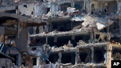 In this picture taken Friday, Feb. 26, 2016, destroyed buildings are seen in the old city of Homs, Syria. About 1,200 rebels and civilians, many of them wounded and starving from a yearlong siege, withdrew from the last remaining strongholds in Homs in May 2014, surrendering to President Bashar Assad a bloodstained city once called the “capital of the revolution.” (AP Photo/Hassan Ammar)