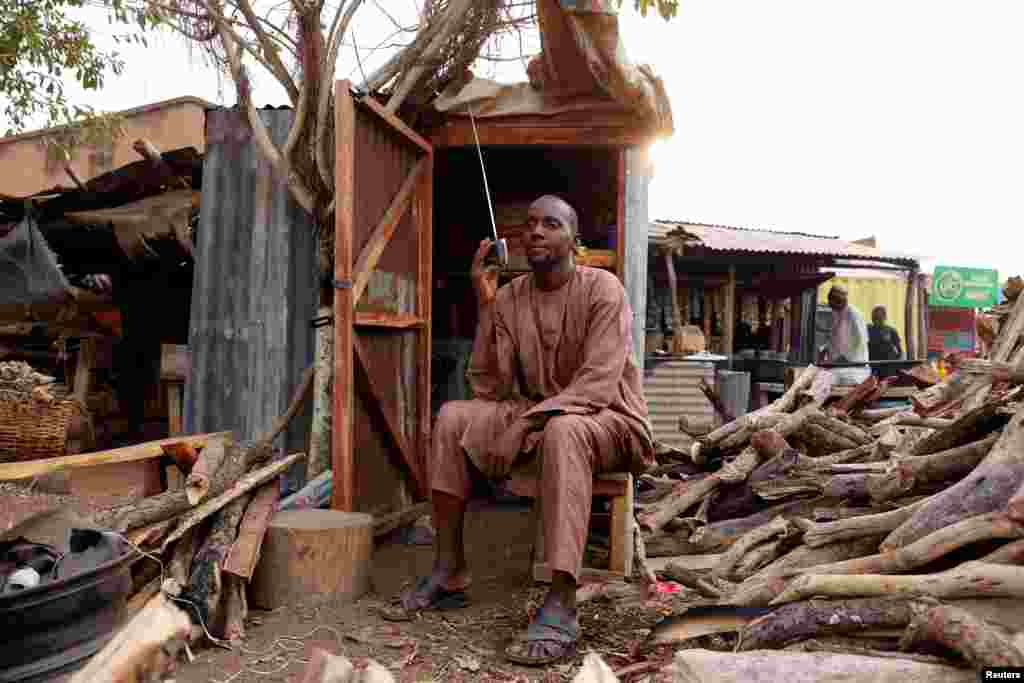 A man listens to the radio as Nigerians await the result of the Presidential election, in Yola, Adamawa State.