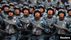 Members of the Gendarmerie Division take part in a parade during its presentation at the headquarters of the Federal Police in Mexico City, Aug. 22, 2014.
