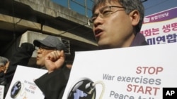 South Korean protesters shout slogans during a rally against the annual joint military exercises between South Korea and the United States, in front of the Yongsan U.S. Army headquarters in Seoul, South Korea, February 27, 2012.