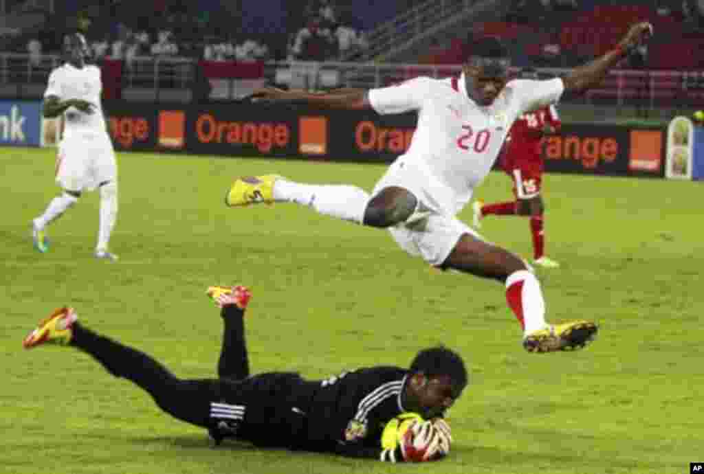 Sudan's goalkeeper Akram El Hadi Salim saves the ball from Issiaka Ouedraogo of Burkina Faso during their African Nations Cup Group B soccer match at Estadio de Bata "Bata Stadium", in Bata January 30, 2012.