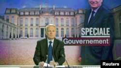 France's Prime Minister Jean-Marc Ayrault takes part in the broadcast news of French TV channel France 2, May 16, 2012 in Paris.