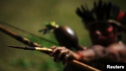 FILE - A Brazilian Indian of the Guarani-Kaiowa tribe patrols after invading a private ranch that they consider part of their "tekoha," or sacred land, in Paranhos, Mato Grosso do Sul state, Sept. 4, 2012. 