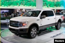 FILE - A 2018 Ford F-150 "King Ranch" pickup truck is displayed during the North American International Auto Show in Detroit, Mich., Jan. 10, 2017. The F-150 is one of several 2018 Ford models on which automatic braking will be offered.