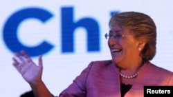 Chilean presidential candidate Michelle Bachelet waves to supporters after leading in the first round of elections in Santiago, Nov. 17, 2013.