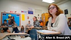 Tenth-grader Emma Preston listens intently during civics class at Chatham Central High School in Bear Creek, N.C., on Tuesday, Nov. 5, 2019. The class is debating whether President Trump should be impeached.