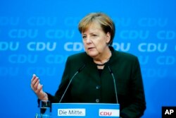 FILE - German Chancellor Angela Merkel addresses a new conference in Berlin, Nov. 27, 2017.