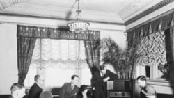 A group of people listening to the radio at the Hamilton Hotel in Washington D.C.