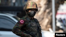 FILE - A Myanmar soldier stands guard in Yangon, Myanmar, Feb. 2, 2021.