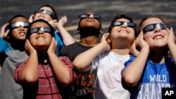 Fourth graders at Clardy Elementary School in Kansas City, Missouri, practice the proper use of their eclipse glasses in anticipation of Monday's solar eclipse, Aug. 18, 2017.