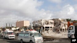 FILE - Ambulances carrying wounded victims passing the scene of a truck bomb blast in Mogadishu, Somalia, Oct. 16, 2017. 