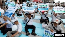 FILE - Protesters take part in a rally in Taipei against Taiwan being excluded from U.N.'s annual World Health Assembly (WHA) in Geneva, Taiwan, May 21, 2017.