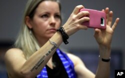 Erin Miller, with a tattoo honoring the Women Airforce Service Pilots, attends a hearing as the Texas school board prepared to vote on history curriculum, Nov. 13, 2018, in Austin, Texas.