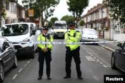 Police officers stand at a road block near a property in East Ham, east London, Britain, June 5, 2017.