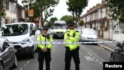 Police officers stand at a road block near a property in East Ham, east London, Britain, June 5, 2017.