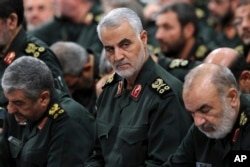 FILE- A photo released by an official website of the office of the Iranian supreme leader, shows Revolutionary Guard Gen. Qassem Soleimani (C) attending a meeting with Supreme Leader Ayatollah Ali Khamenei and Revolutionary Guard commanders in Tehran, Ira