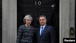 Britain's Prime Minister Theresa May greets Hungary's Prime Minister Viktor Orban at Downing Street in London, Nov. 9, 2016.