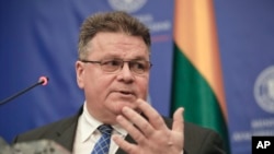 Lithuania's foreign minister Linas Linkevicius gestures during a joint press conference with Romanian counterpart Teodor Melescanu in Bucharest, Romania, , March 26, 2018.