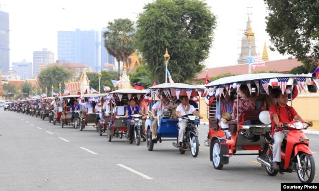 U.S. embassy employees sit in tuk-tuks, decorated with American flags, and kick-off activities marking 70 years of Cambodia-US relations in a parade along the streets in Phnom Penh, 2020. (Photo courtesy of U.S. Embassy in Cambodia)
