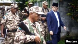 Ông Murad Ebrahim, thủ lãnh Mặt trận Hồi giáo Giải phóng Moro, đi đến cuộc họp báo bên trong trại của ông ở Sultan Kudarat, tỉnh Maguindanao, miền nam Philippines, ngày 5/9/2011. 