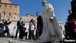 Pope Francis arrives to lead his Wednesday general audience in Saint Peter's square at the Vatican, Sept. 25, 2013.