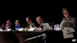 Members of the Nebraska Public Service Commission, from right: Mary Ridder, Frank Landis, Tim Schram, Crystal Rhoades, left and Rod Johnson, second left, look at documents in Lincoln, Neb., Aug. 7, 2017, as they hold the first of a five-day public hearing.