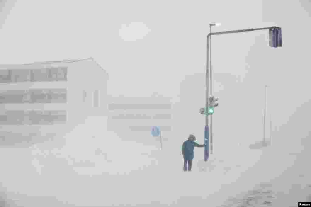 A person is seen during a snowstorm in Nuuk, Greenland, March 14, 2022. 