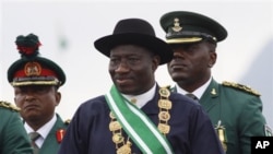Nigerian President Goodluck Jonathan, center, inspects a guard of honor during his inauguration ceremony at the main parade ground in Nigeria's capital of Abuja. Jonathan was sworn in Sunday for a full four-year term as president of Nigeria, May 29, 2011