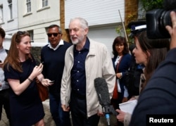 FILE - Britain's opposition Labour Party leader Jeremy Corbyn (C) leaves his home in London, June 26, 2016.
