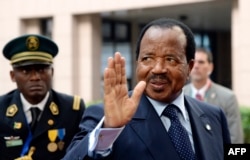 FILE - Cameroon's President Paul Biya waves.